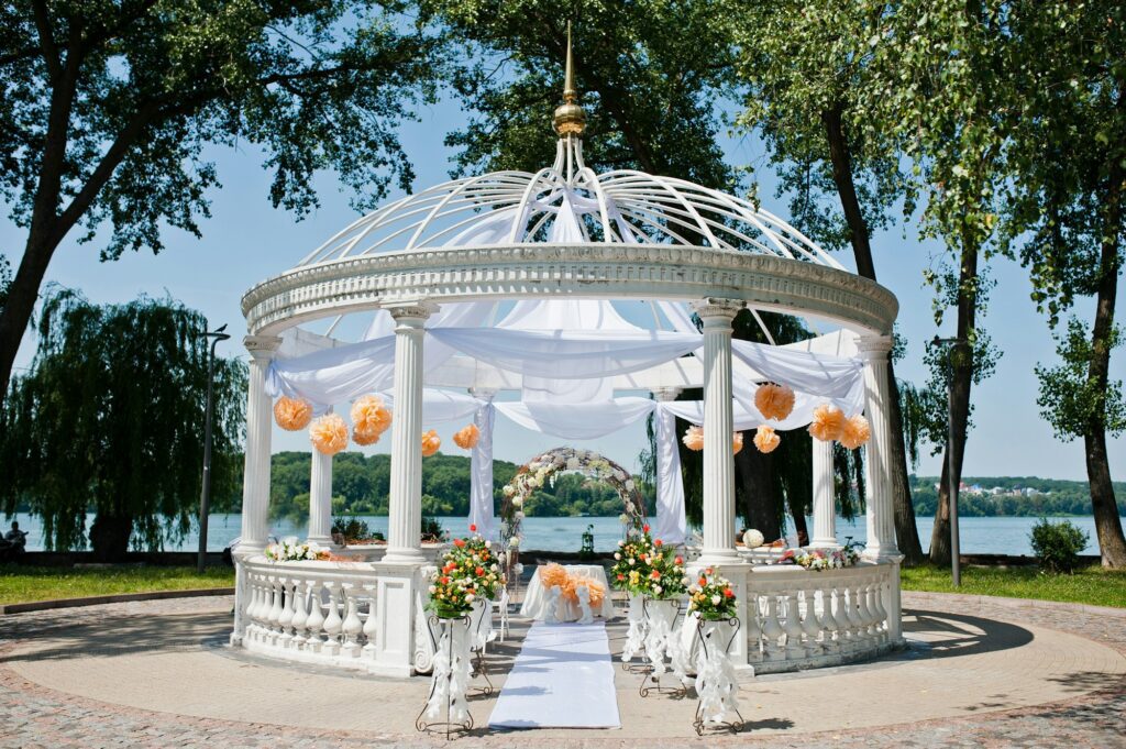 wedding arch with chairs and many flowers and decor